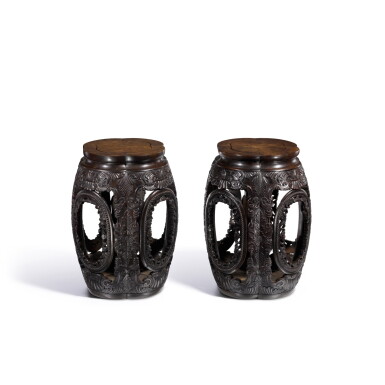 View full screen - View 1 of Lot 3766. A pair of carved zitan barrel-form stools, Qing dynasty, Qianlong period | 清乾隆 紫檀雕卷草紋四開光座墩一對.