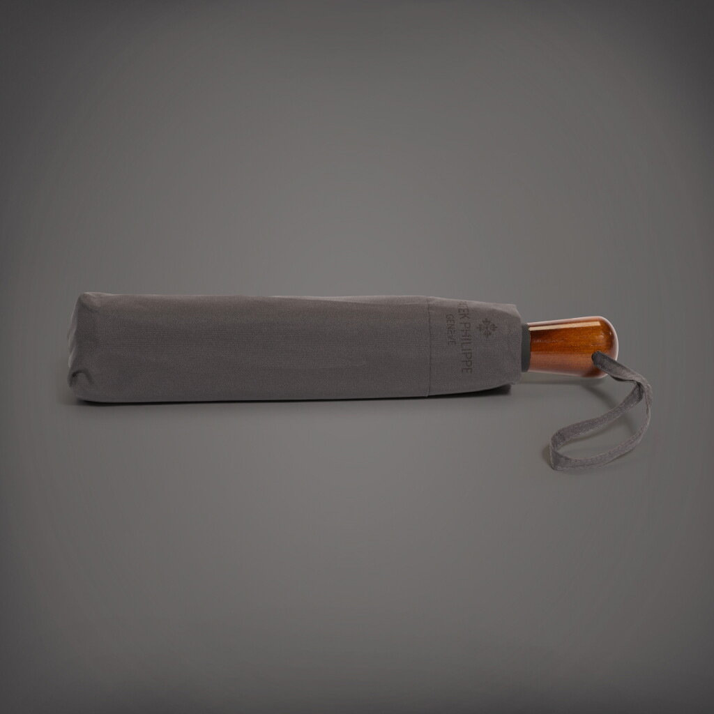 View full screen - View 1 of Lot 89. A brown automatic folding compact umbrella with wooden handle | Circa 2018.