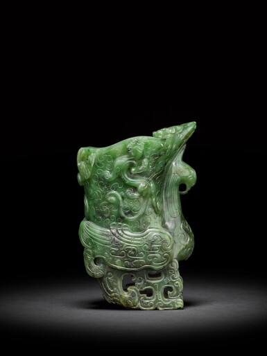 View full screen - View 1 of Lot 10. A spinach-green jade archaistic 'phoenix' rhyton, Qing dynasty, 18th century | 清十八世紀 碧玉雕仿古祥鳳螭龍觥 .