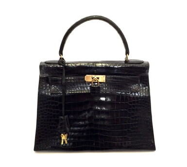 View full screen - View 1 of Lot 743. HERMÈS | BLACK KELLY 28 IN SHINY CROCODILE WITH GOLD HARDWARE, 1962.