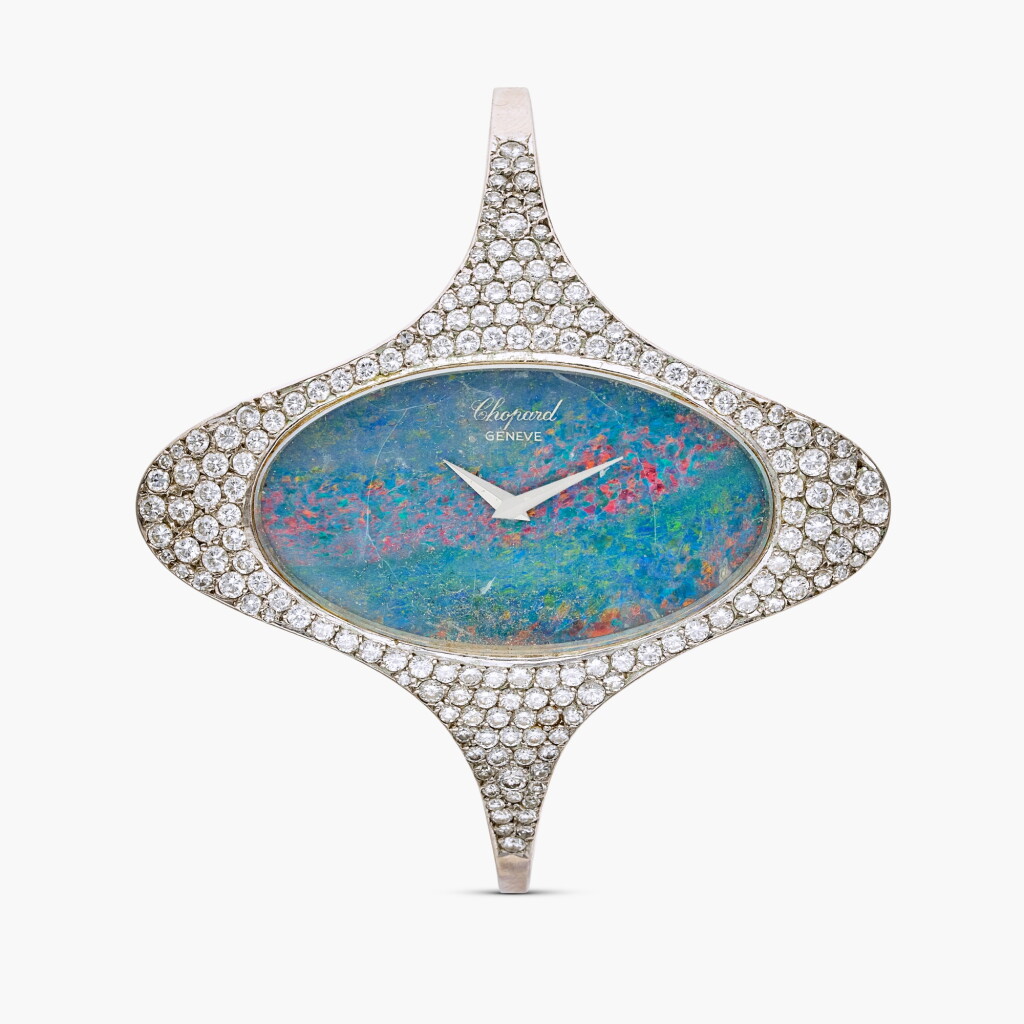 View full screen - View 1 of Lot 664. Reference 5038-1 | A white gold and diamond-set cuff watch with opal dial, Circa 1970.