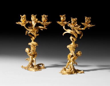View full screen - View 1 of Lot 55. A pair of Louis XV giltbronze candelabra, after a model by Meissonnier | Paire de candélabres aux enfants en bronze doré d'époque Louis XV, d'après un modèle de Meissonnier.