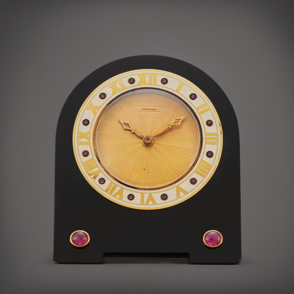 View full screen - View 1 of Lot 82. An onyx, enamel, gold and ruby-set desk timepiece, Circa 1910.