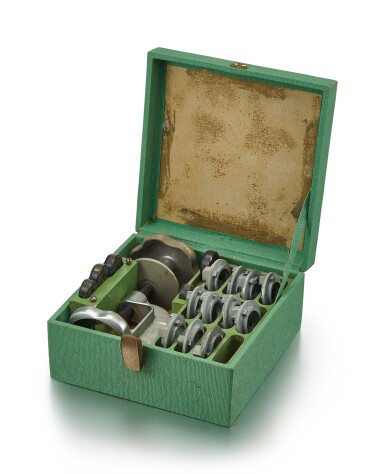 View full screen - View 1 of Lot 8102. ROLEX | EASY OYSTER OPENER, REFERENCE 1001, A STEEL CASE OPENER WITH 11 CAST FOR VARIOUS CASE SIZES, 5 ADAPTORS FOR VARIOUS CASE BACK SIZES AND ORIGINAL FITTED BOX, CIRCA 1955.