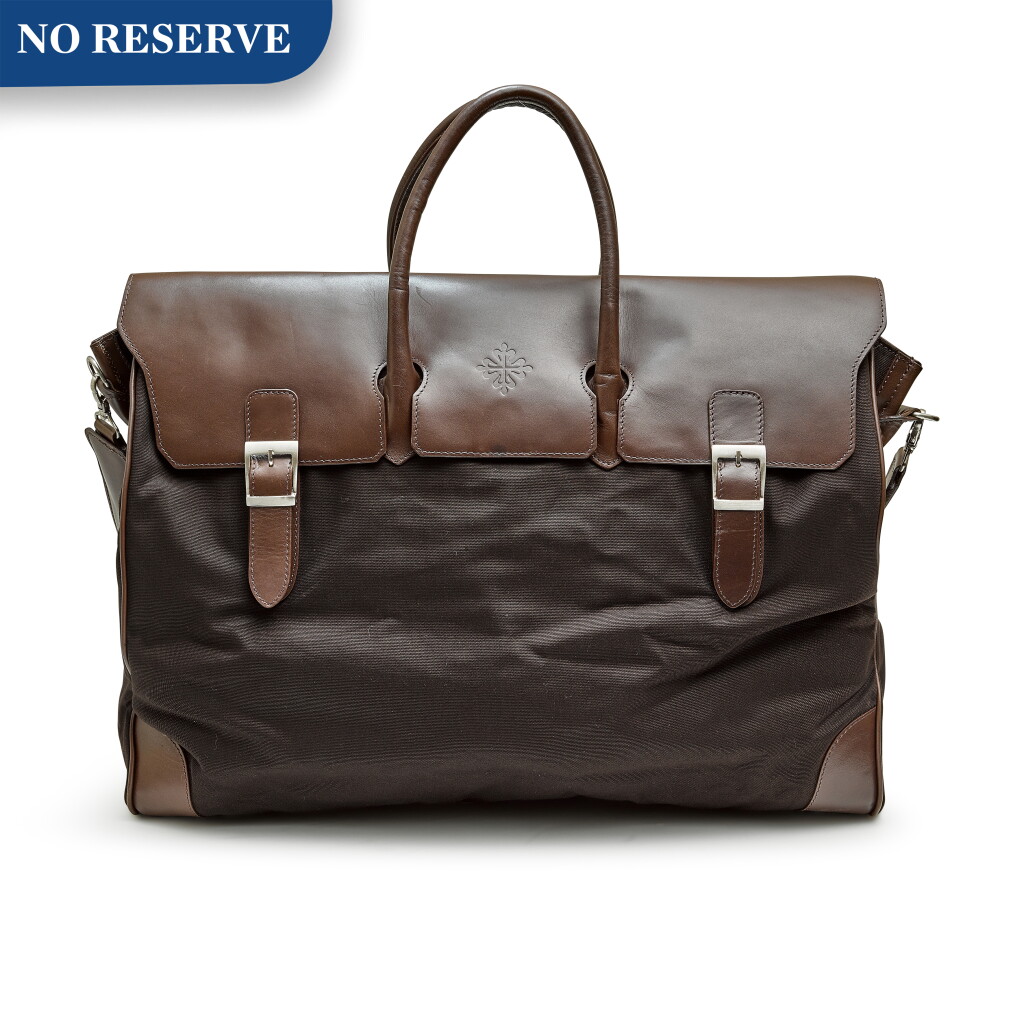 View full screen - View 1 of Lot 8082. PATEK PHILIPPE | A BROWN LEATHER AND CANVAS TRAVLLING BAG AND COPPER HARDWARE, CIRCA 2012.