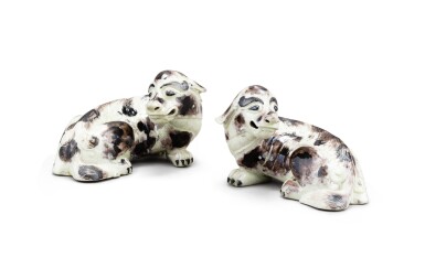 View full screen - View 1 of Lot 144. Two moulded buff and aubergine-glazed figures of recumbent dogs Probably Japan, Edo period | 或為日本 江戶時代 黃褐釉臥犬擺件兩件.