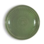 A large 'Longquan' celadon-glazed dish, Early Ming dynasty | 明初 龍泉窰青釉印花大盤