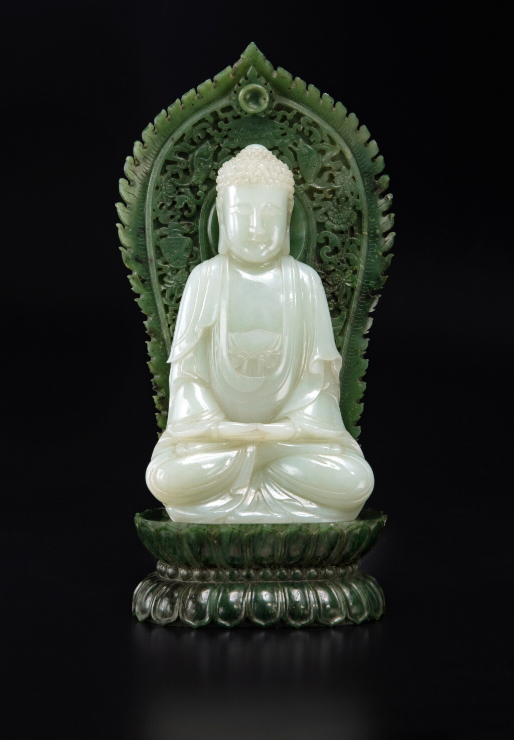 View full screen - View 1 of Lot 61. A very rare pale celadon jade figure of Buddha and spinach-green jade stand, Qing dynasty, Qianlong period | 清乾隆 青白玉雕佛坐像連碧玉蓮座.