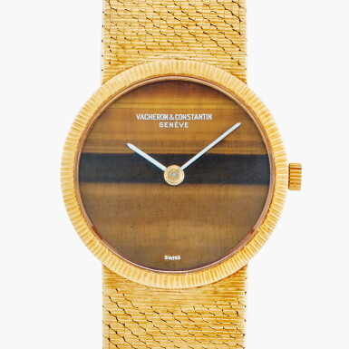 View full screen - View 1 of Lot 666. Reference 6898 P | A yellow gold bracelet watch with tiger's eye dial, Circa 1970.