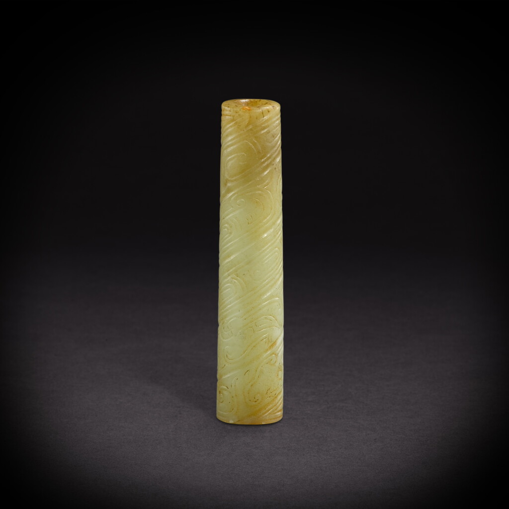View full screen - View 1 of Lot 6826. A yellowish-celadon jade 'dragon' bead, Western Zhou dynasty | 西周 青黃玉龍紋管形飾.