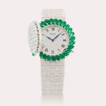 Reference 9177 A6 | A white gold, emerald and diamond-set bracelet watch with concealed dial, Circa 1965