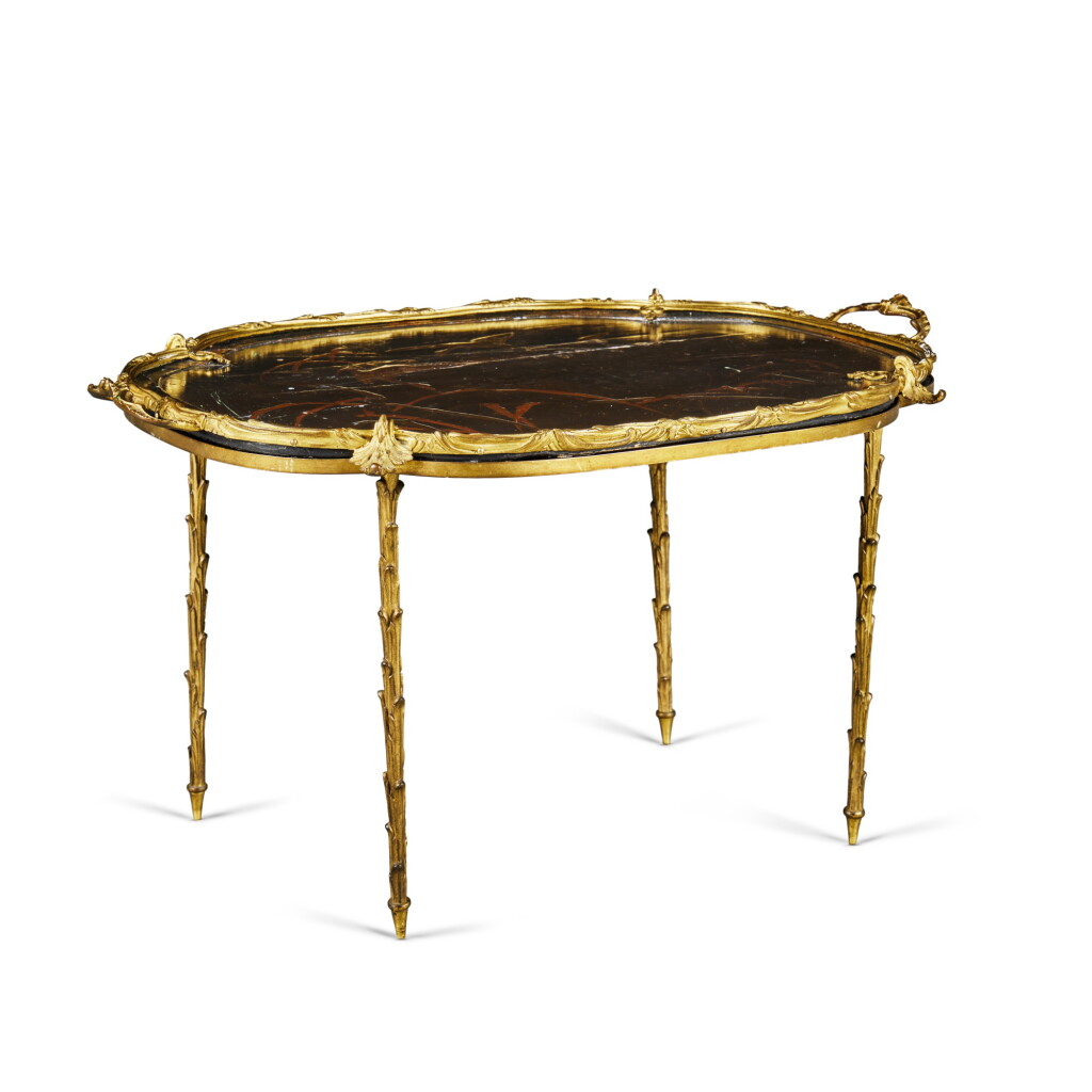 View full screen - View 1 of Lot 343. A French Gilt-Bronze Red and Black Japanned Two-Handled Tray on Stand, Probably by Maison Jansen.