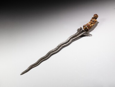 View full screen - View 1 of Lot 24. An inlaid gilt-copper repoussé kriss depicting Buta Sari, Indonesia, Bali, probably 20th century | 印尼巴里島 或二十世紀 格里斯嵌寶劍.