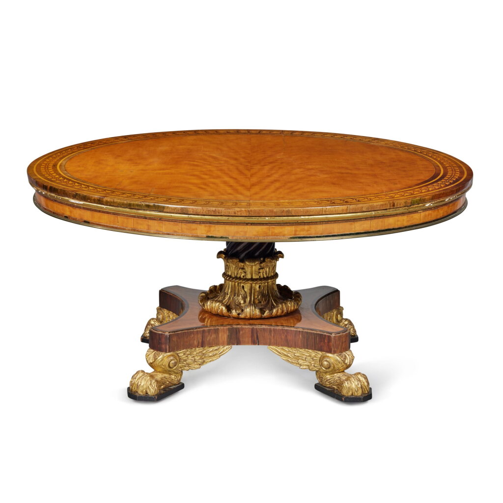 View full screen - View 1 of Lot 380. A Large Regency Circular Parcel-Gilt Satinwood and Rosewood Marquetry Centre Table, Circa 1820.