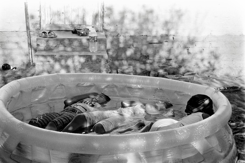 View full screen - View 1 of Lot 17. Kids refresh themselves in the afternoon Summer heat of Pienaar Sig. Nieu-Bethesda .