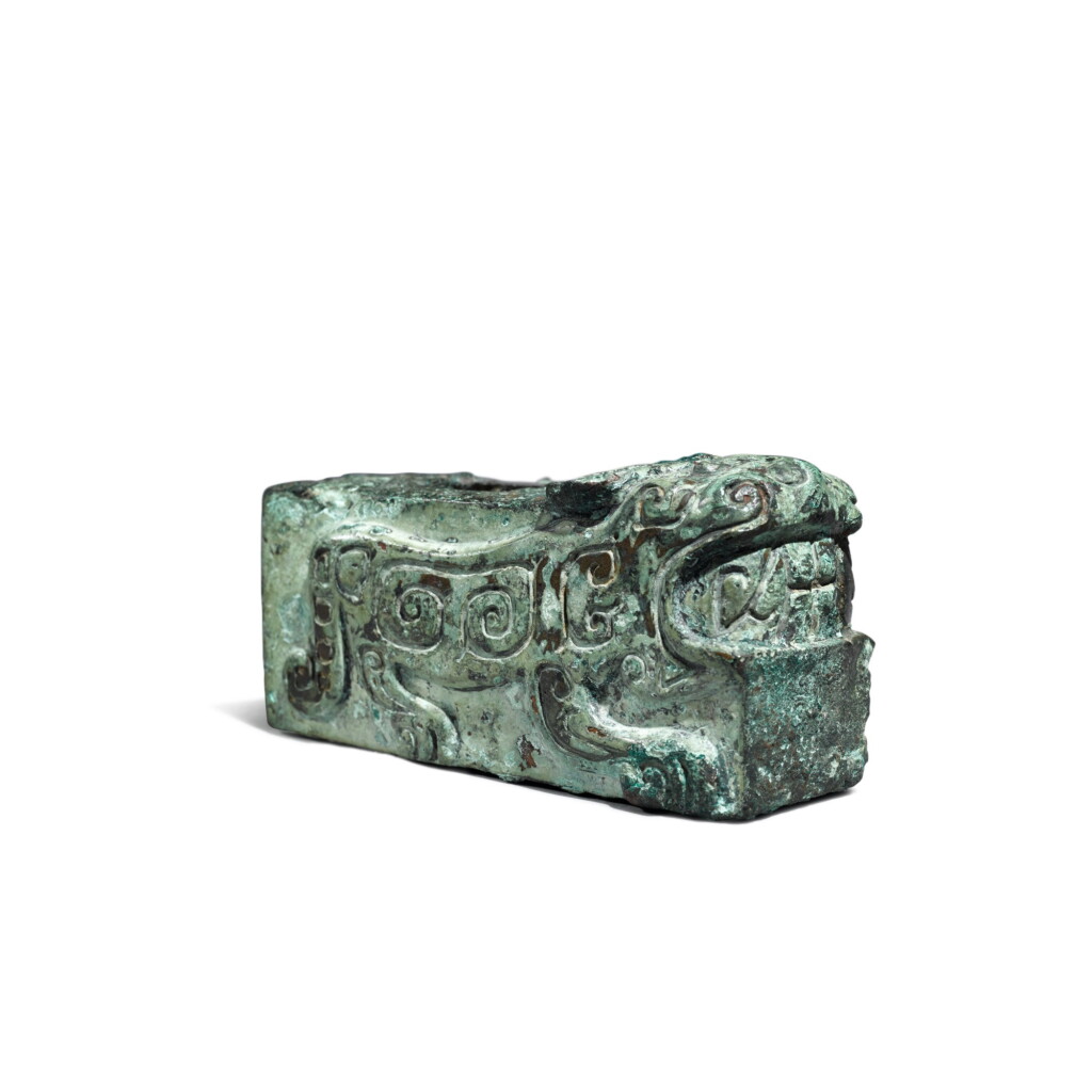 View full screen - View 1 of Lot 24. An archaic bronze 'tiger' fitting, Shang dynasty | 商 青銅虎紋部件.