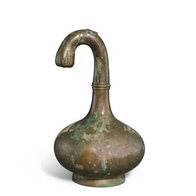 View full screen - View 1 of Lot 754. A bronze 'garlic head' wine vessel, hu, Western Han dynasty | 西漢 青銅曲頸蒜頭瓶.