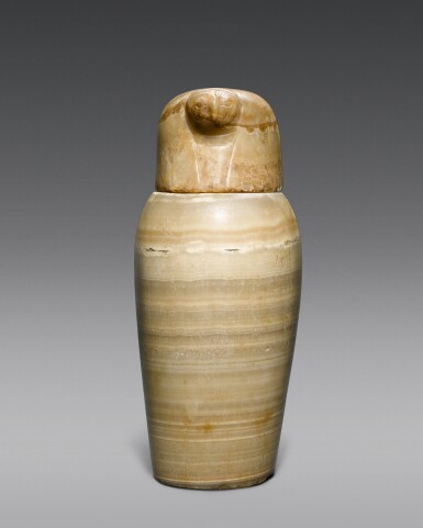 View full screen - View 1 of Lot 137. An Egyptian Alabaster Canopic Jar and Lid, 26th/ 30th Dynasty, 664-342 B.C..