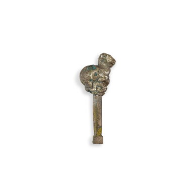 View full screen - View 1 of Lot 548. A silver-gilt bronze 'ram' zither tuning key, Eastern Zhou dynasty, Warring States period 東周戰國 銅鎏銀臥羊琴軫鑰.