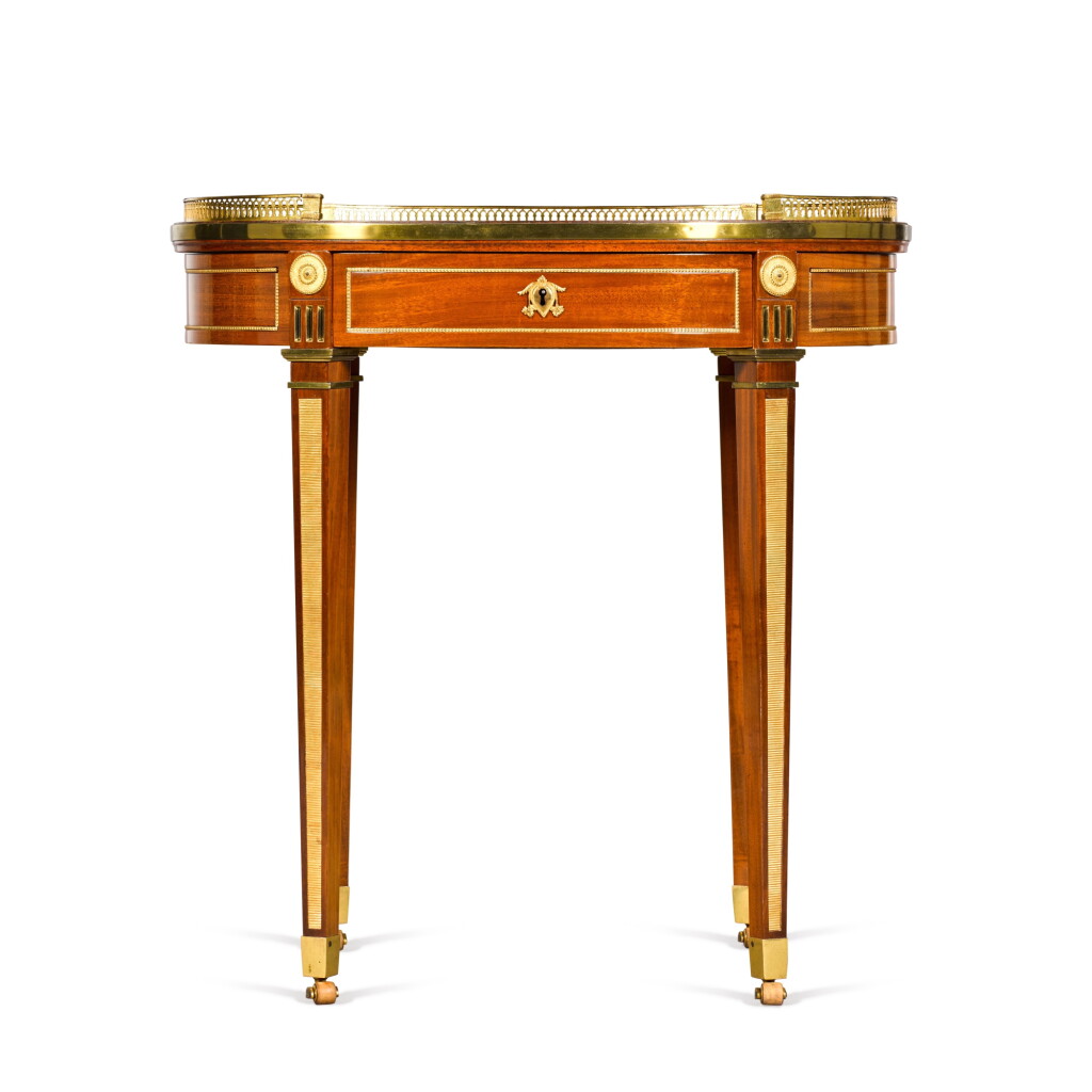 View full screen - View 1 of Lot 15. A German gilt-bronze mounted mahogany writing table, circa 1785-90, attributed to David Roentgen.