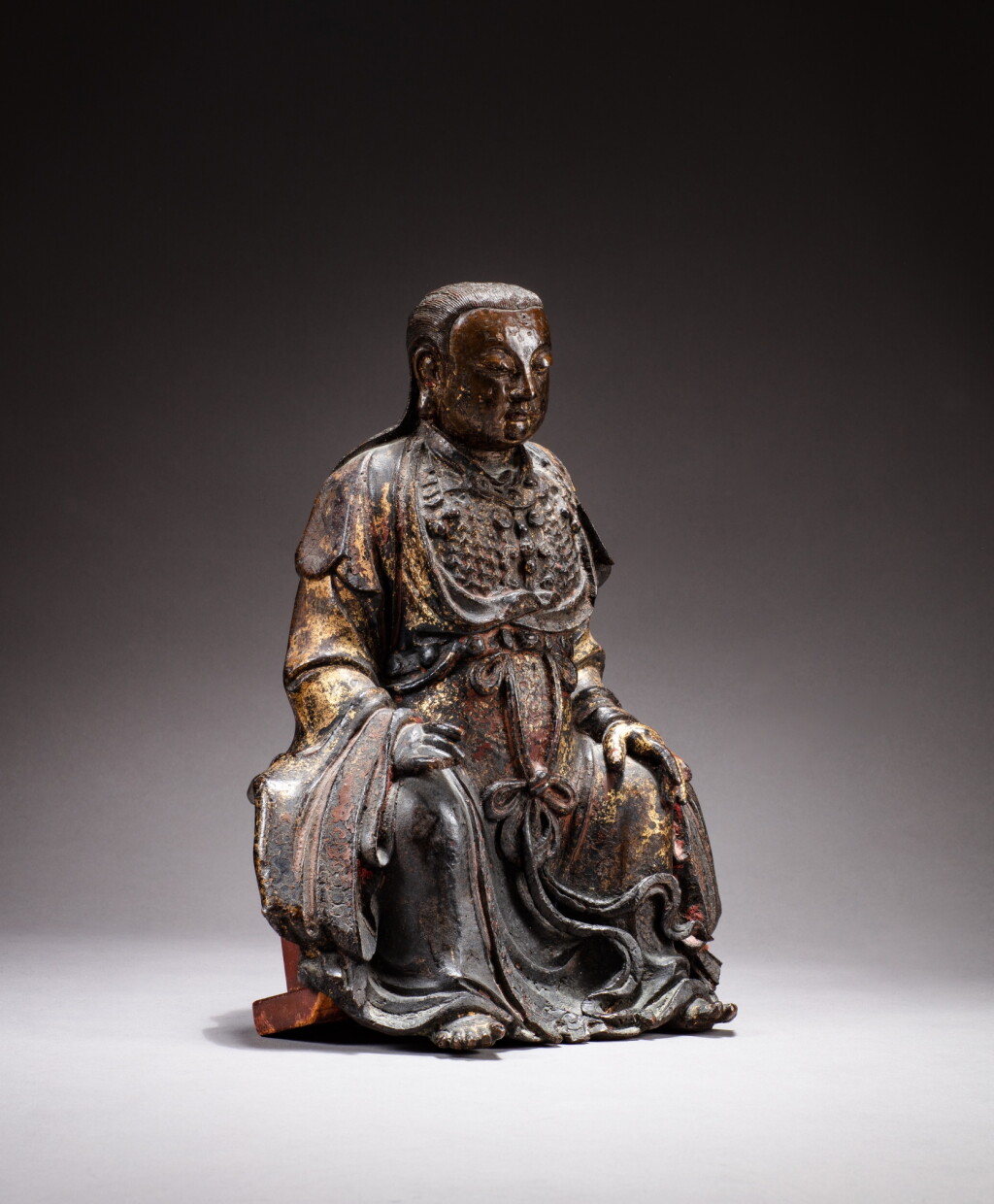 View full screen - View 1 of Lot 42. A gilt-lacquer bronze figure of Zhenwu, Qing dynasty, 17th century | 清十七世紀 銅漆金真武坐像.