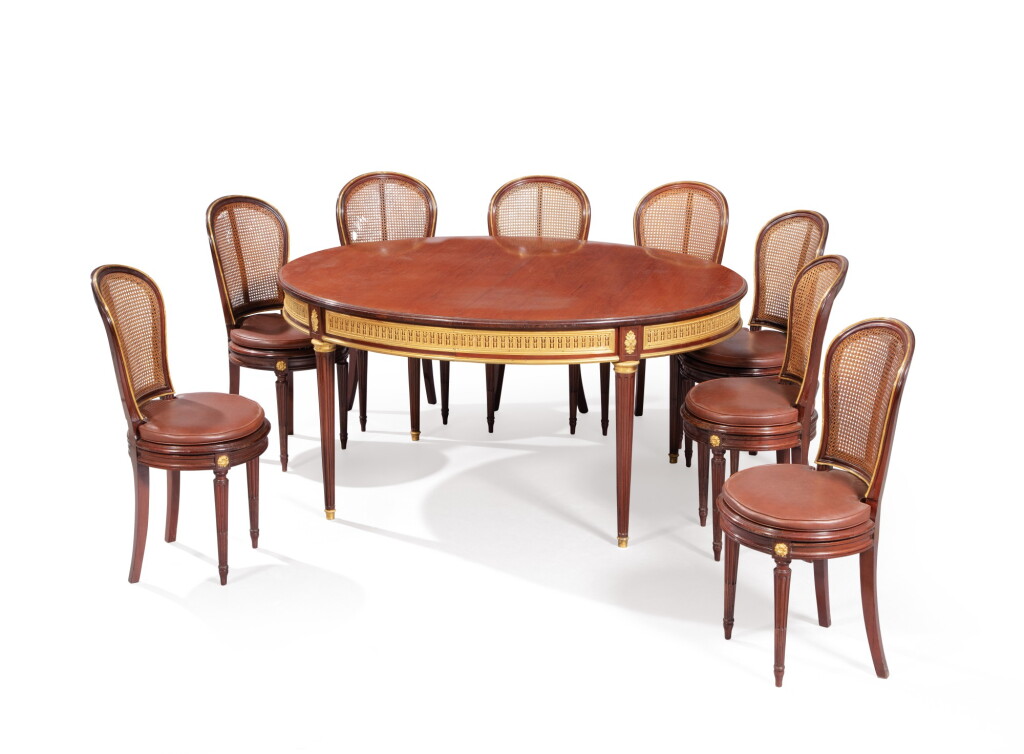 View full screen - View 1 of Lot 186. A mahogany dining table and eight chairs, attributed to François Linke (1855-1946) .