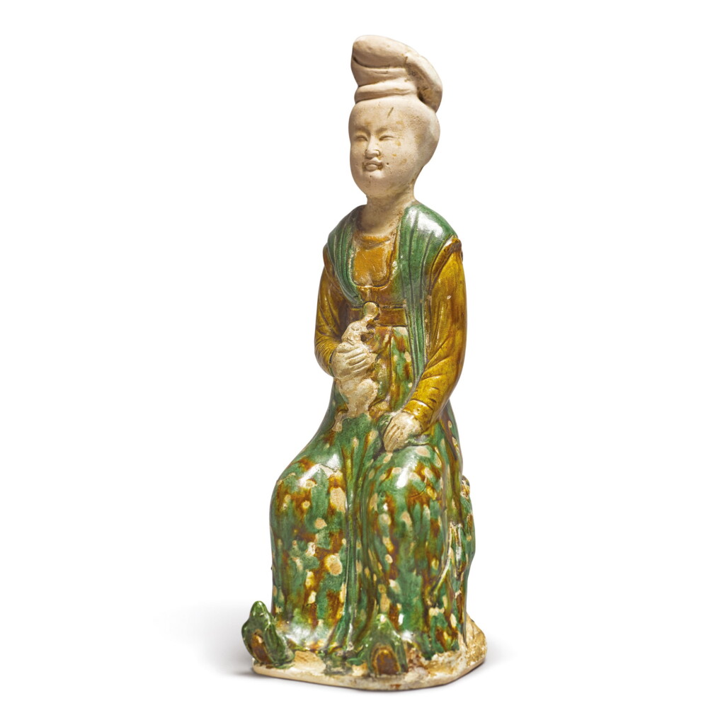 View full screen - View 1 of Lot 691. A RARE SANCAI-GLAZED POTTERY FIGURE OF A SEATED COURT LADY, TANG DYNASTY.