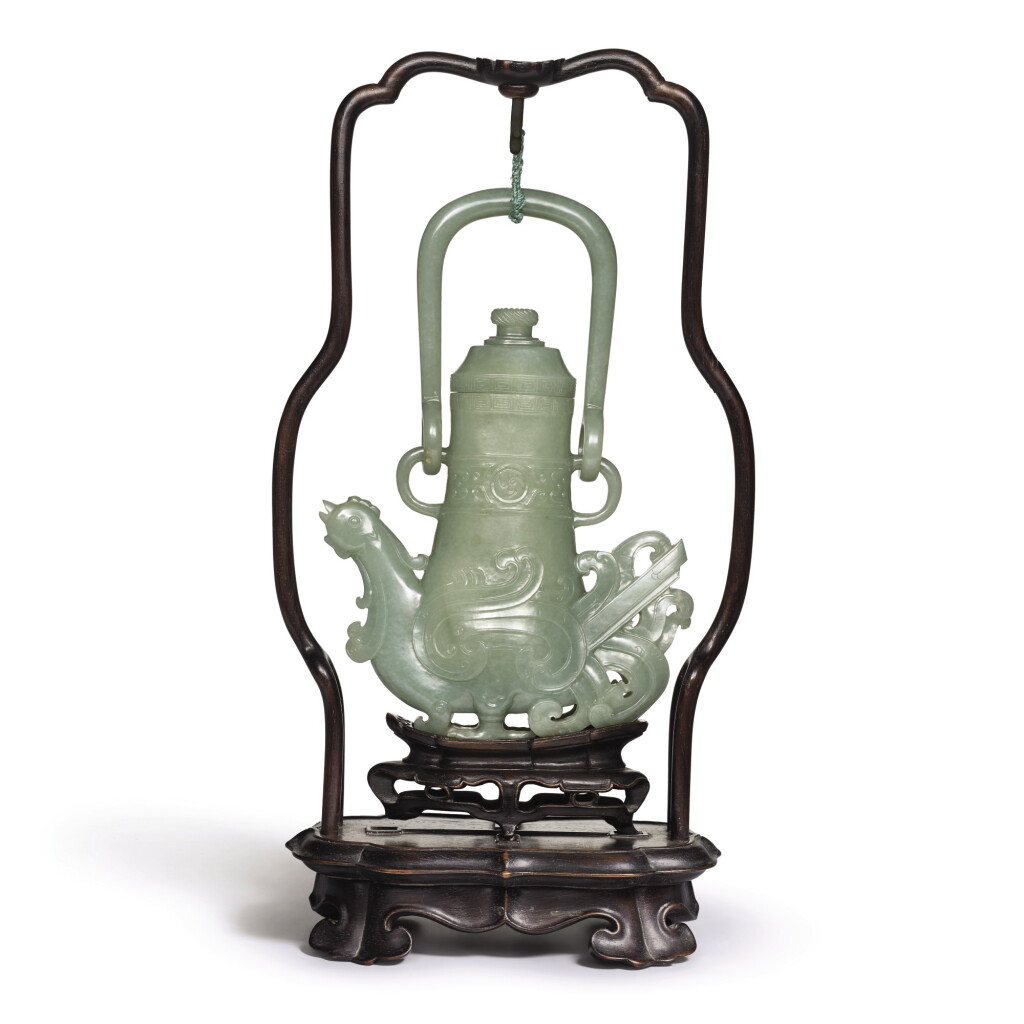View full screen - View 1 of Lot 215. A CELADON JADE ARCHAISTIC 'PHOENIX' EWER AND COVER, QING DYNASTY, 18TH CENTURY | 清十八世紀 青玉仿古夔鳳形提梁壺.