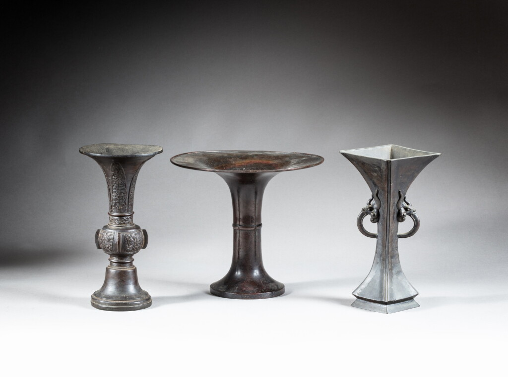 View full screen - View 1 of Lot 29. A group of three archaistic bronze vases (Gu), late Ming dynasty | 明末 銅出㦸花觚一組三件.