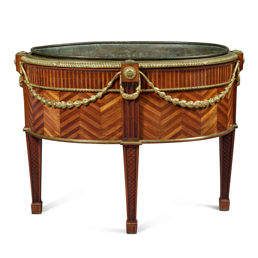 View full screen - View 1 of Lot 1154. A George III Gilt-Bronze and Brass-Mounted Mahogany, Satinwood and Amaranth Wine Cooler, Circa 1780 and later.