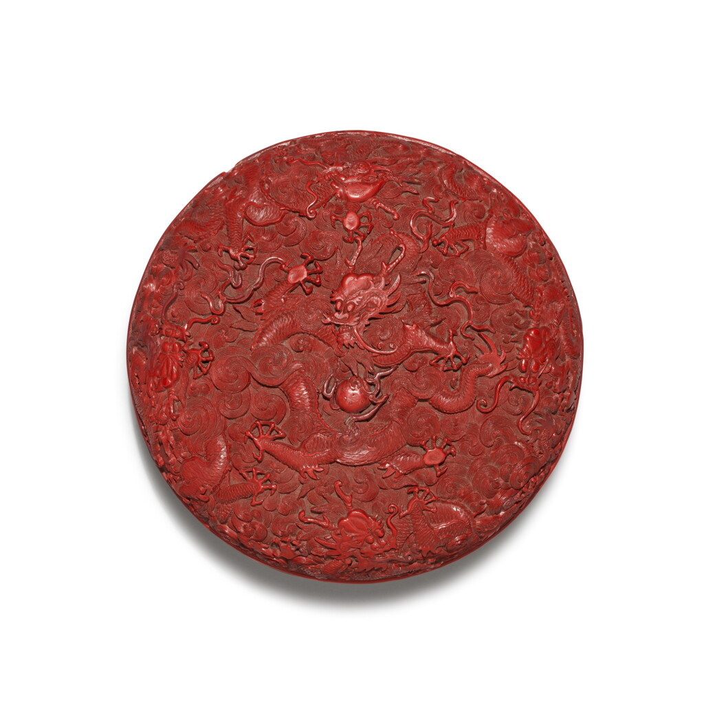 View full screen - View 1 of Lot 32. A carved cinnabar lacquer 'dragon' box and cover, Qing dynasty, Qianlong period | 清乾隆 剔紅遊龍趕珠紋圓蓋盒.