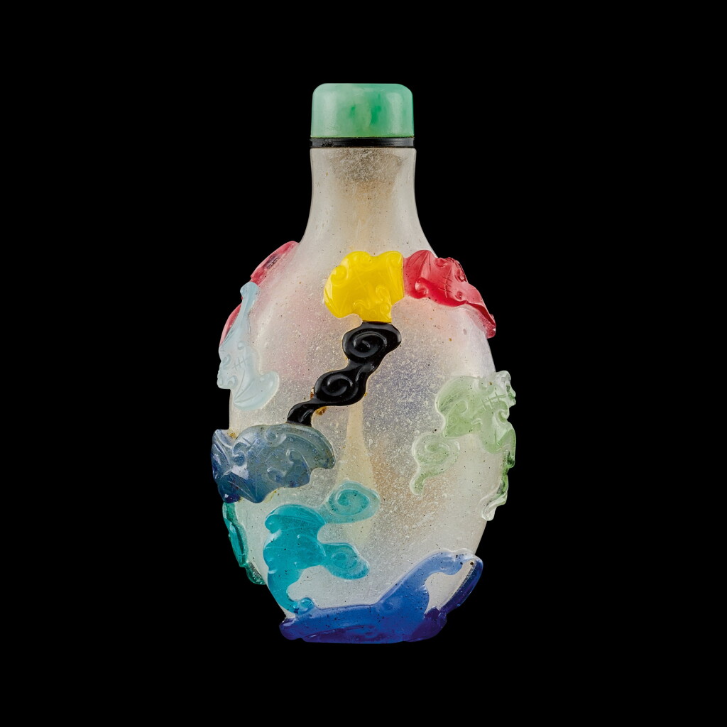View full screen - View 1 of Lot 1052. A multi-colour overlay glass 'bats and clouds' snuff bottle Qing dynasty, 18th - 19th century | 清十八至十九世紀 雪霏地套料雲蝠紋鼻煙壺.