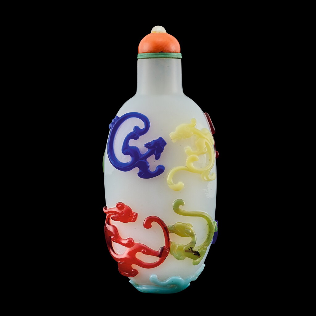 View full screen - View 1 of Lot 1001. A five-colour overlay glass 'nine dragons' snuff bottle, Qing dynasty, late 18th century | 清十八世紀末 涅白地套五色料九螭龍紋鼻煙壺.
