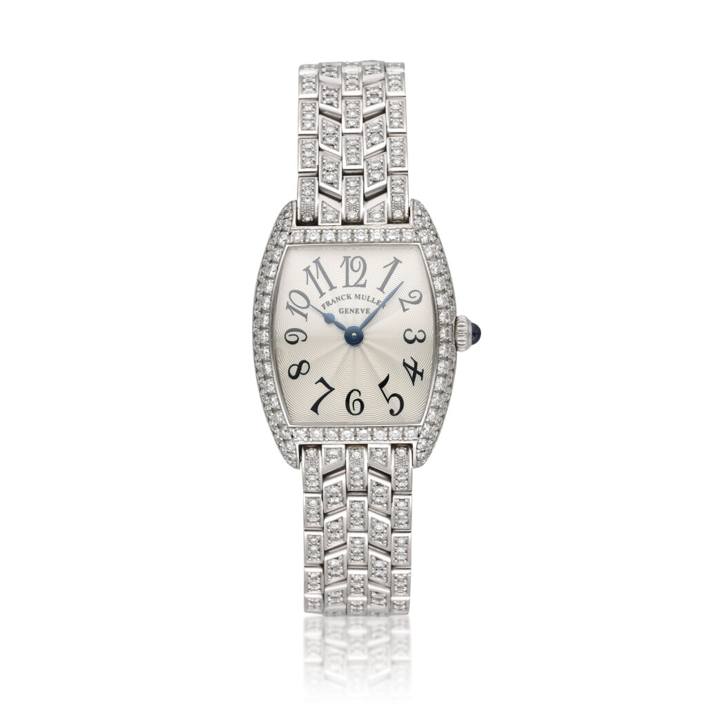 View full screen - View 1 of Lot 339. Reference 2251 QZ D Cintree Curvex | A white gold and diamond-set tonneau shaped bracelet watch, Circa 2000.