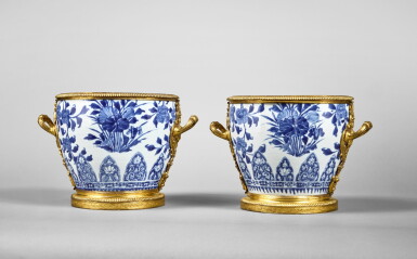 View full screen - View 1 of Lot 508. A Pair of Late Louis XIV Gilt-Bronze Mounted Blue and White Porcelain Cache-Pots, the Porcelain Kangxi (1662-1722), the Mounts Circa 1715.