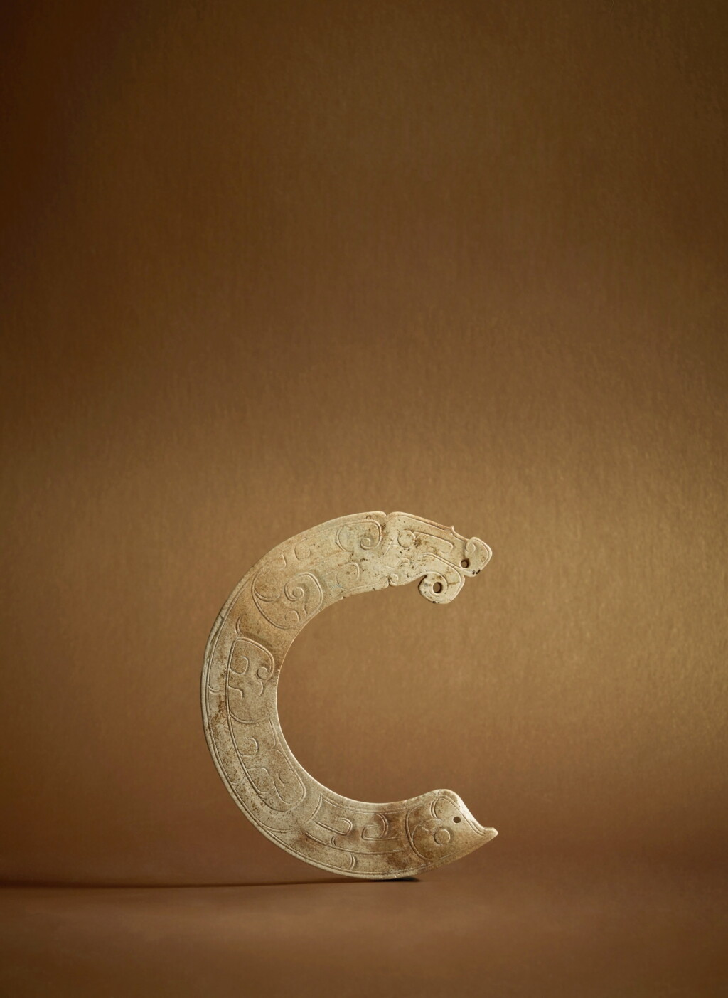 View full screen - View 1 of Lot 80. A rare archaic jade 'dragon' pendant (Huang), Early Western Zhou dynasty.