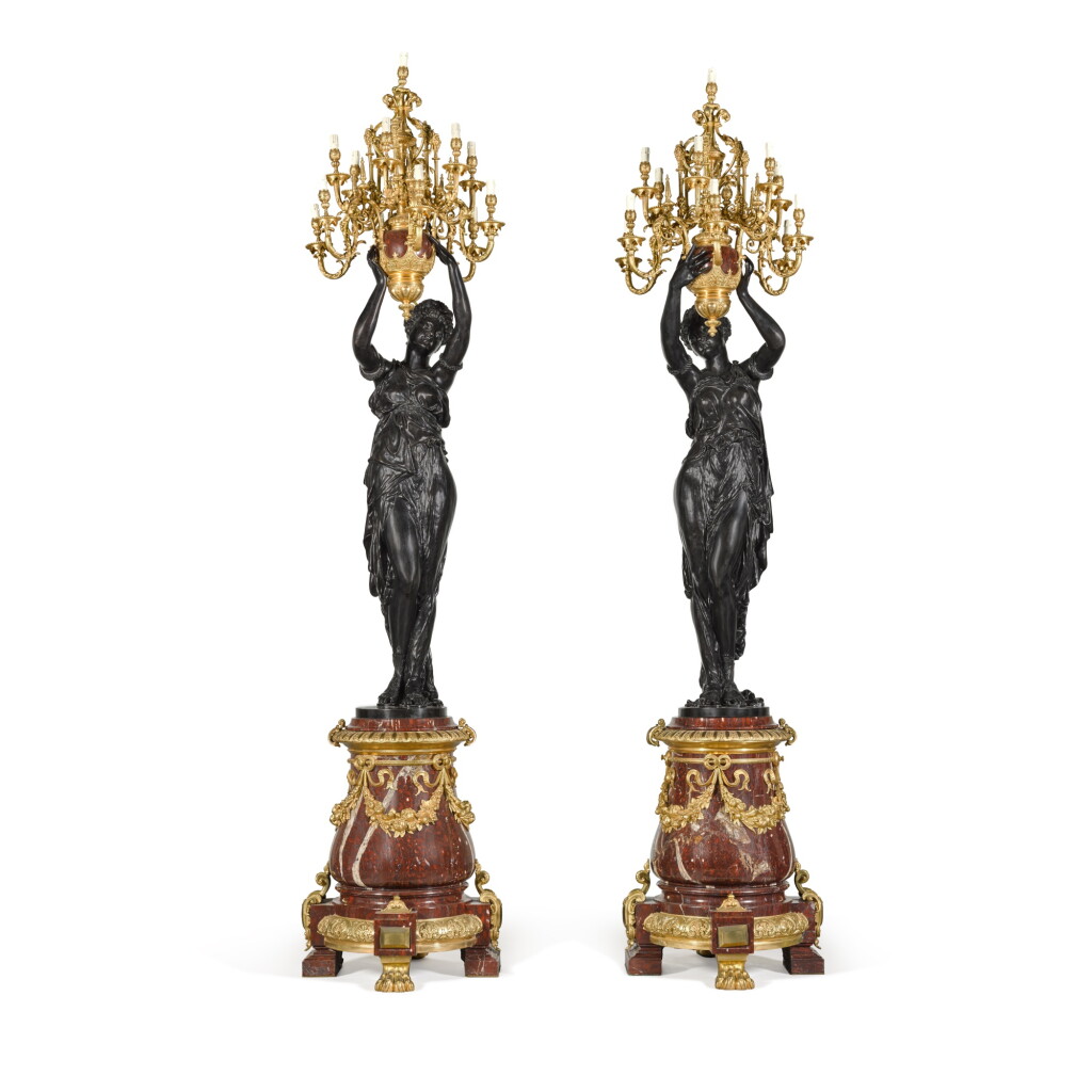 View full screen - View 1 of Lot 10. A pair of gilt and patinated bronze thirteen-light candelabra, second half 20th century, after models by Albert-Ernest Carrier-Belleuse.