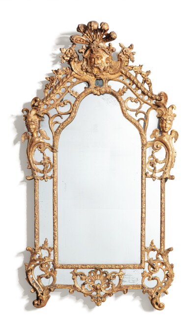 View full screen - View 1 of Lot 150. A LOUIS XV CARVED GILTWOOD MIRROR | MIROIR EN BOIS SCULPTÉ ET DORÉ DU DÉBUT DE L'ÉPOQUE LOUIS XV.