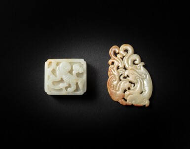 View full screen - View 1 of Lot 135. A reticulated white and russet jade 'dragon and phoenix' pendant and a white jade 'lion' belt plaque, Yuan - Ming dynasty.