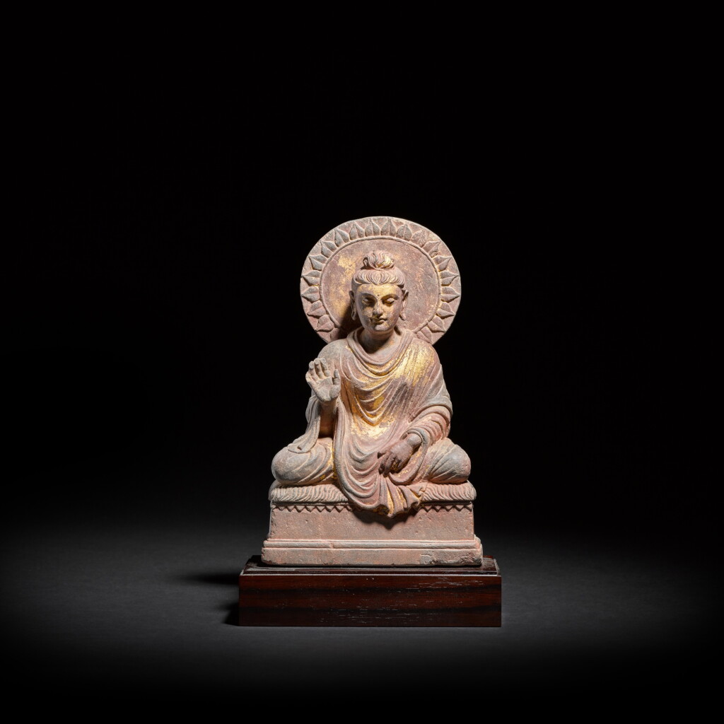 View full screen - View 1 of Lot 819. A gilt-decorated schist figure of seated Shakyamuni Buddha, Ancient Region of Gandhara, circa 2nd / 3rd century.