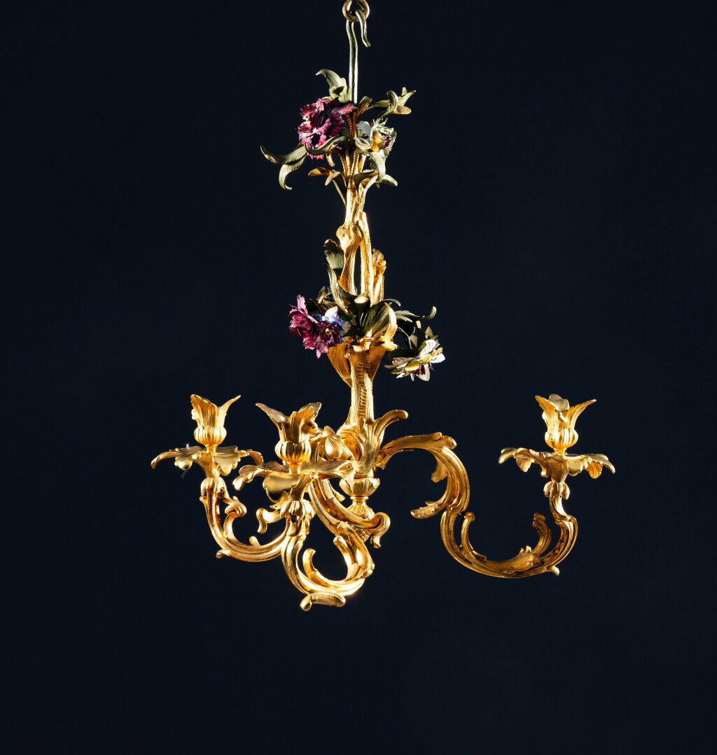 View full screen - View 1 of Lot 30. An Austrian gilt-bronze and painted enamel three-light chandelier, Vienna, circa 1760, attributed to Christoph and Johann von Jünger.