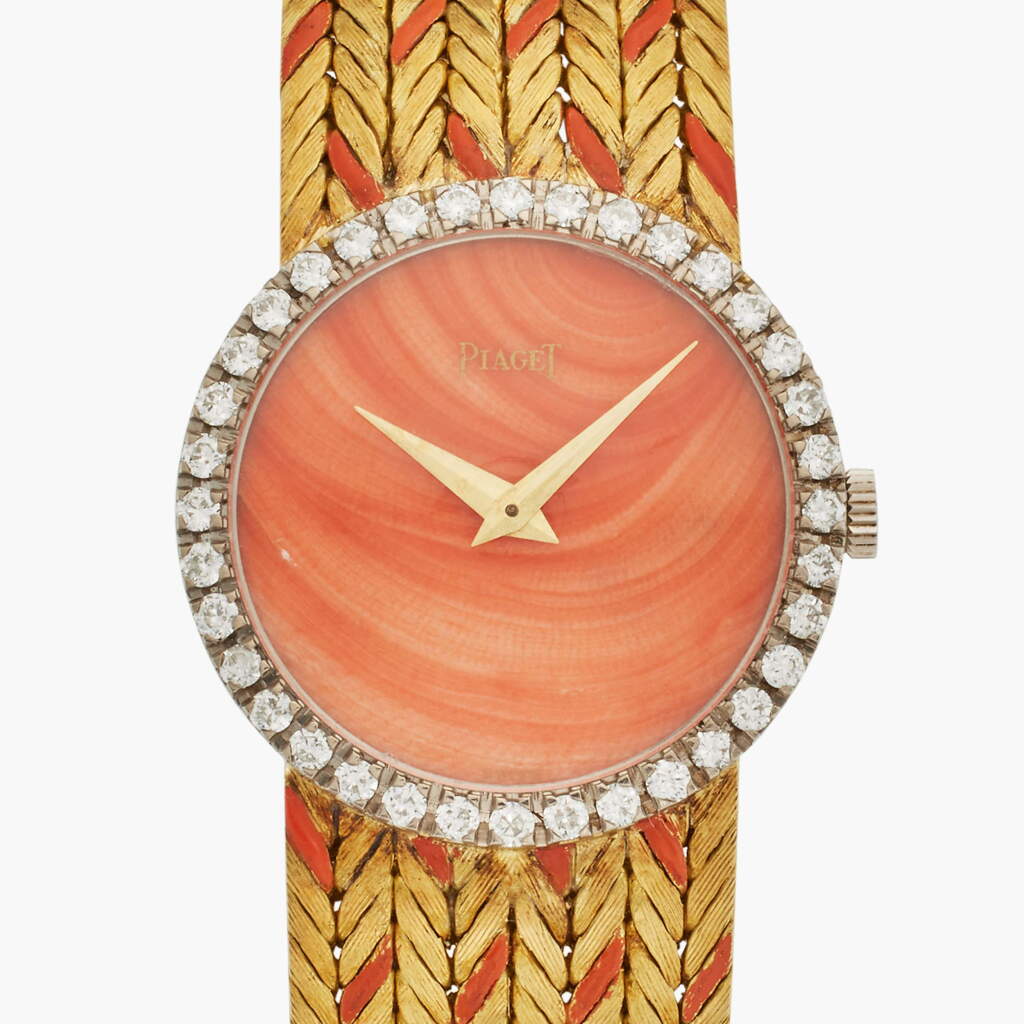 View full screen - View 1 of Lot 126. Reference 9706 E12 | A yellow gold and diamond-set bracelet watch with coral dial, Circa 1967.