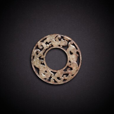 View full screen - View 1 of Lot 9459. A reticulated celadon jade 'chilong' ring, huan, Eastern Zhou dynasty, Warring states period - Han dynasty | 東周戰國至漢 青玉鏤雕螭龍紋環.