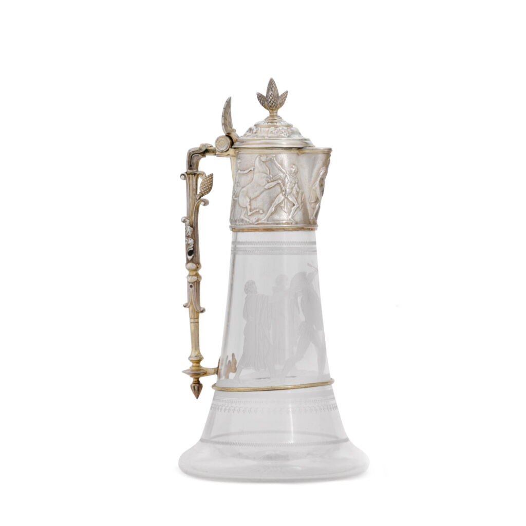Voir en plein écran - Voir 1 du lot 26. A Victorian parcel-gilt silver-mounted glass claret jug, Elkington & Co., Birmingham, 1875.