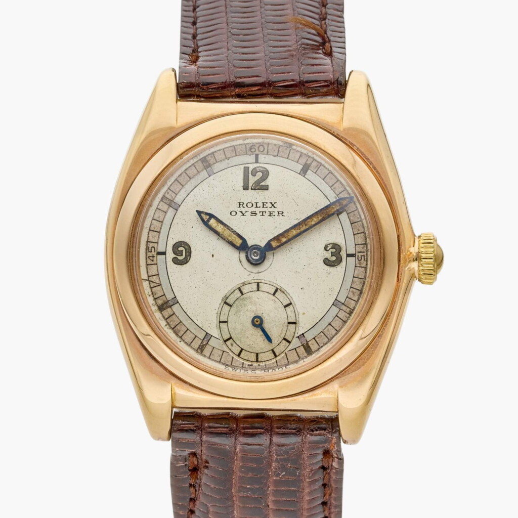 View full screen - View 1 of Lot 404. Reference 3009 Bubbleback 'Flatback' | A pink gold mechanical wristwatch with sector dial, Circa 1944.
