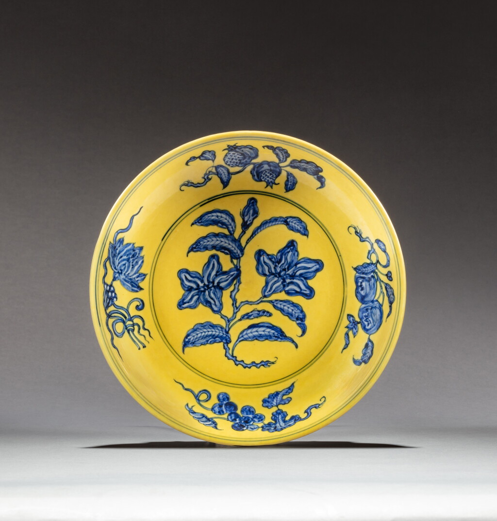 View full screen - View 1 of Lot 151. A fine and rare yellow-ground blue and white 'gardenia' dish, Mark and period of Zhengde | 明正德 黃地青花梔子花盤 《大明正德年製》款.