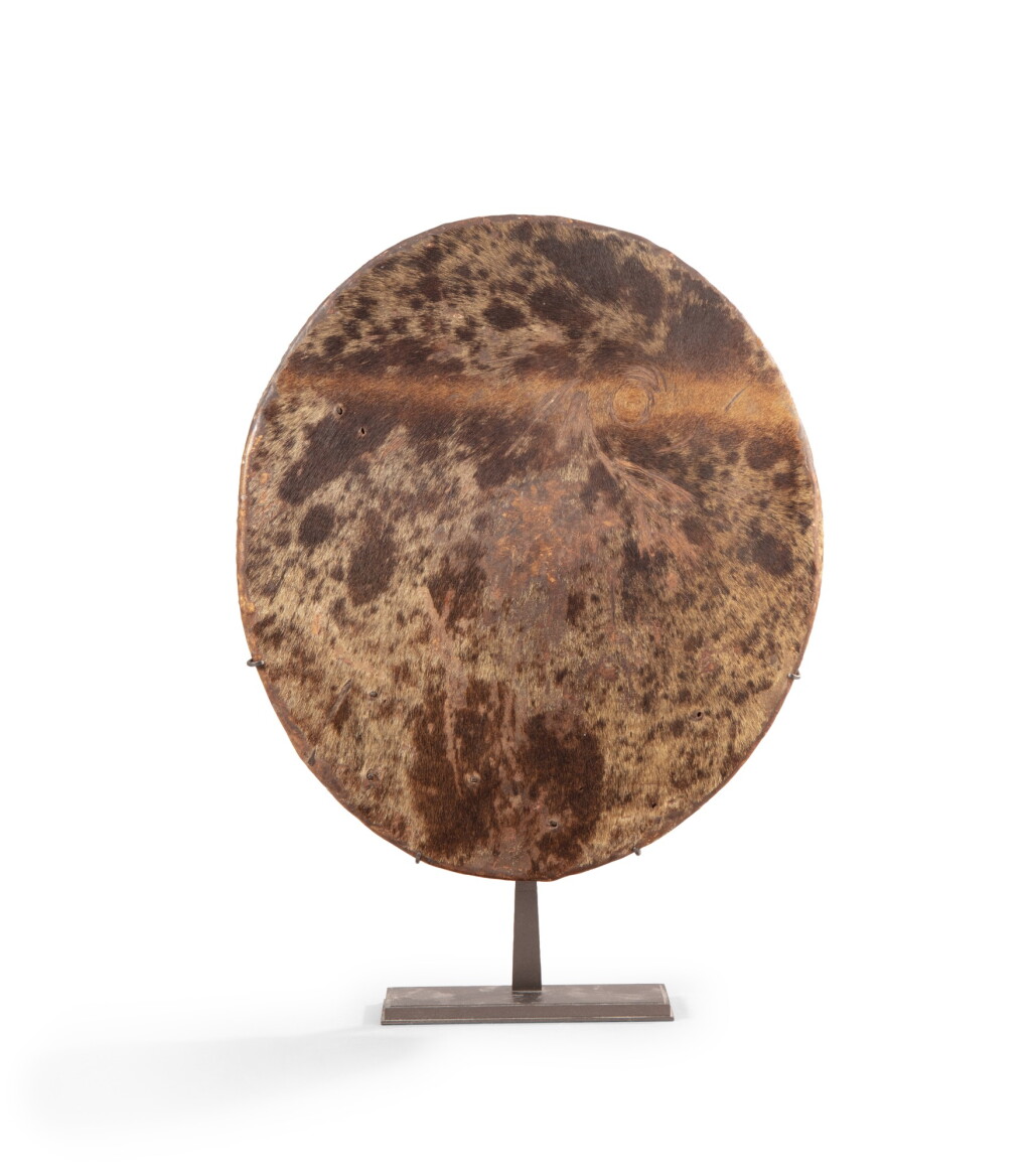 View full screen - View 1 of Lot 326. Sakalava Shield, Madagascar, late 19th-early 20th century | Bouclier, Sakalava, Madagascar, fin XIXe-début XXe siècle Peau de zèbre.