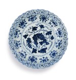 An exceptional and rare blue and white barbed 'grape' charger Ming Dynasty, Yongle Period | 明永樂 青花葡萄紋折沿菱口盤