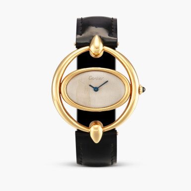 View full screen - View 1 of Lot 2407. Montre bracelet Curviligne dans Anneaux Ovale | An extremely rare and unusual yellow gold oval wristwatch within a larger oval frame with teardrop t-bar lugs and original gold deployant buckle with the clasp of matching design, Circa 1971-72.
