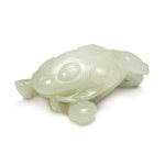 A white jade carving of a three-legged toad, Qing dynasty, 19th / 20th century | 清十九 / 二十世紀 白玉雕金蟾石榴把件